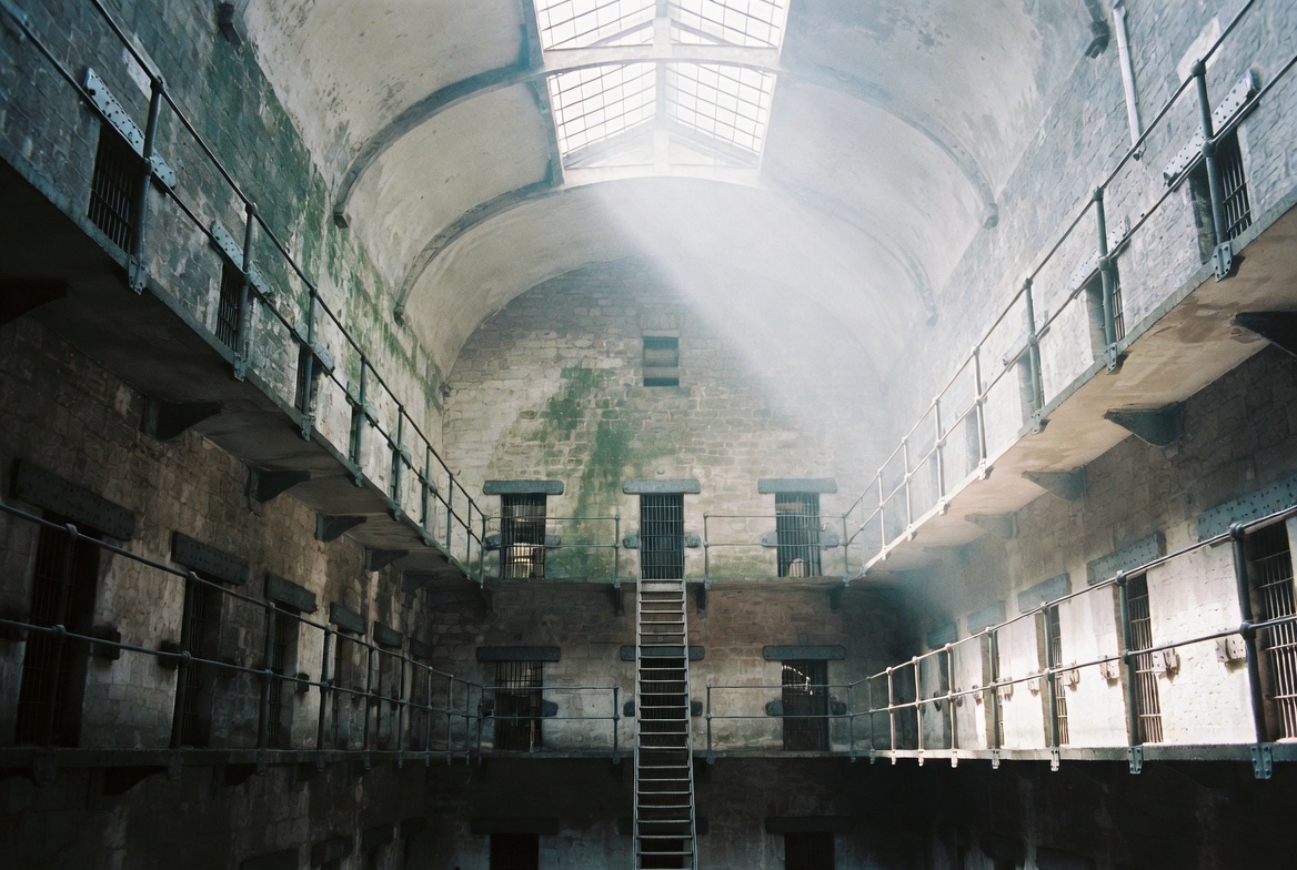 The vaulted east wing of Kilmainham, with three tiers of iron walkways and a central skylight.