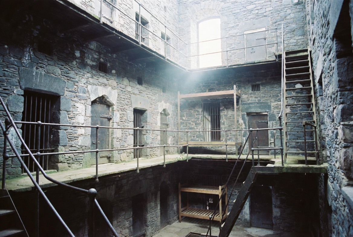 A narrow stone staircase rising sharply between thick walls.